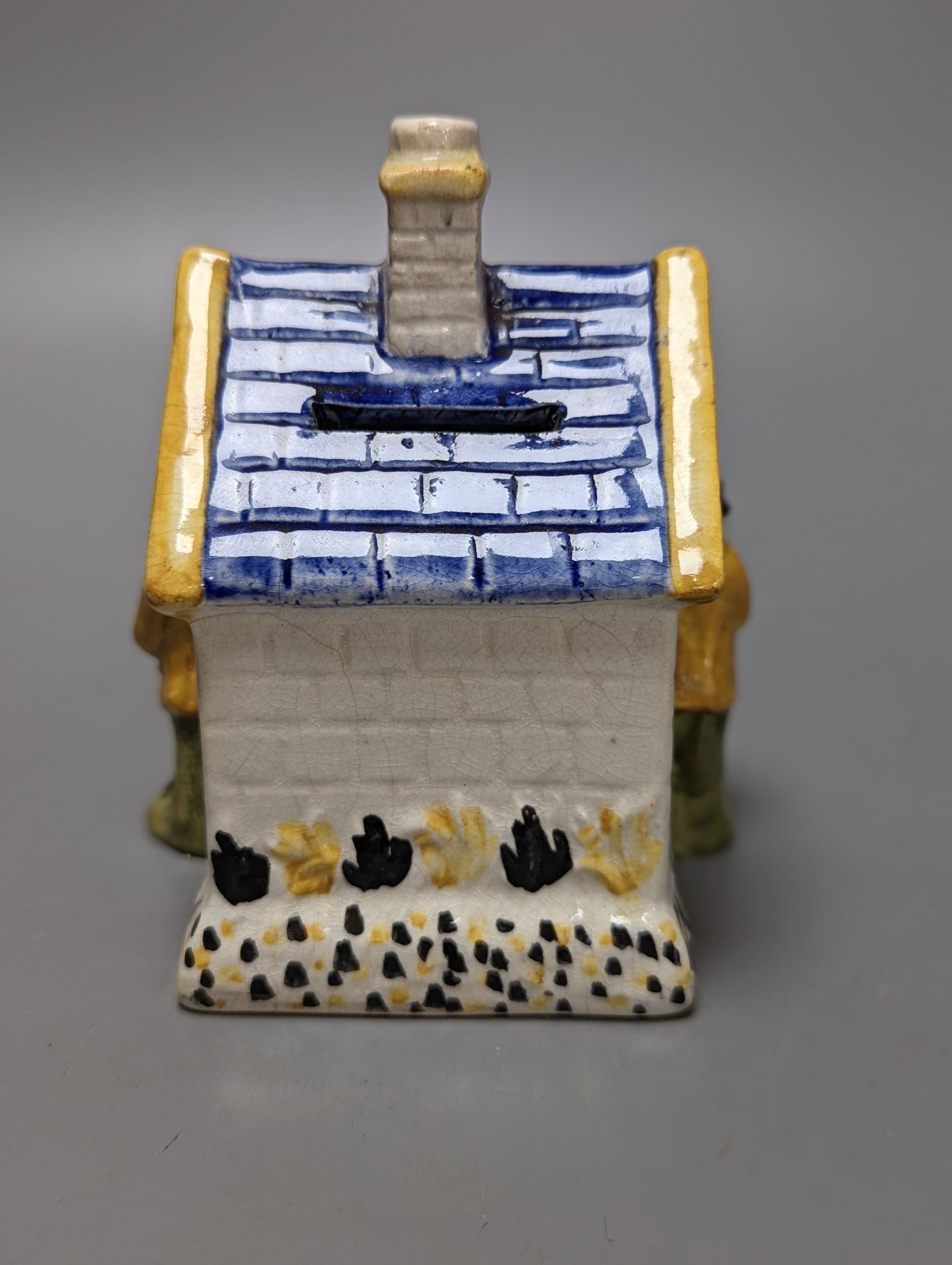 A Staffordshire Prattware money box, c.1810, and another later example (2) both 12.5cm, faults
